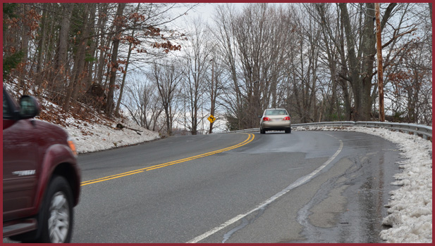 cars going around curve in road